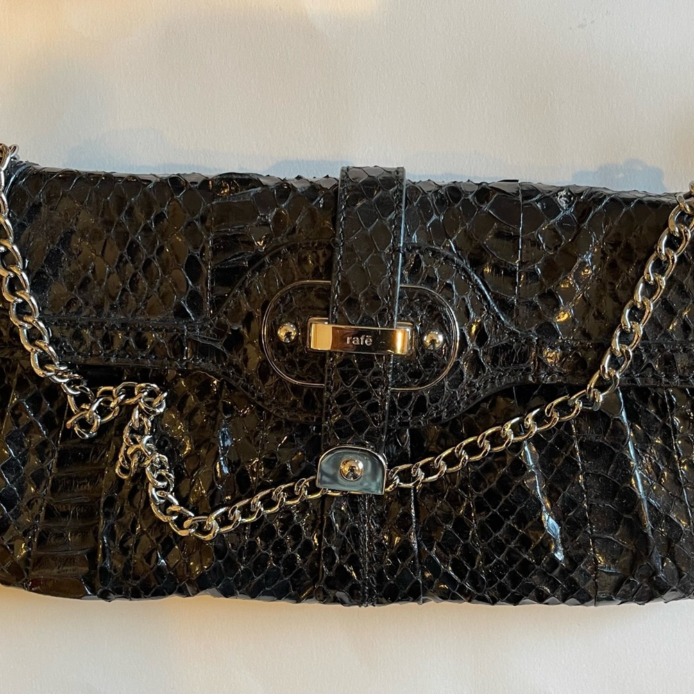 Black snakeskin clutch with silver clasp and chain